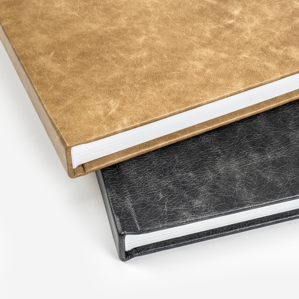 Two leather wedding albums, one light and one dark