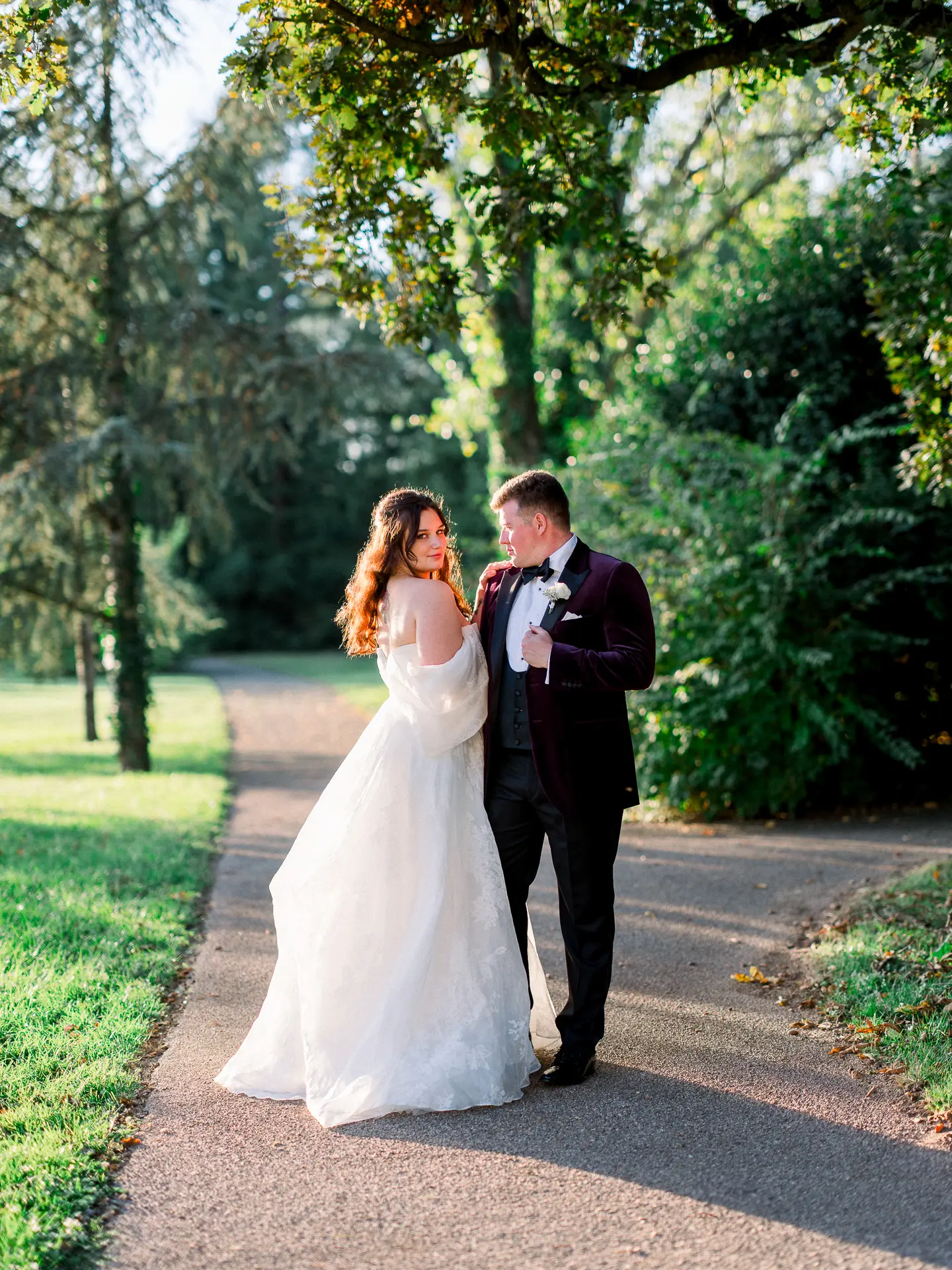 Elegant wedding couple walking in a château park in France captured in fine art natural light